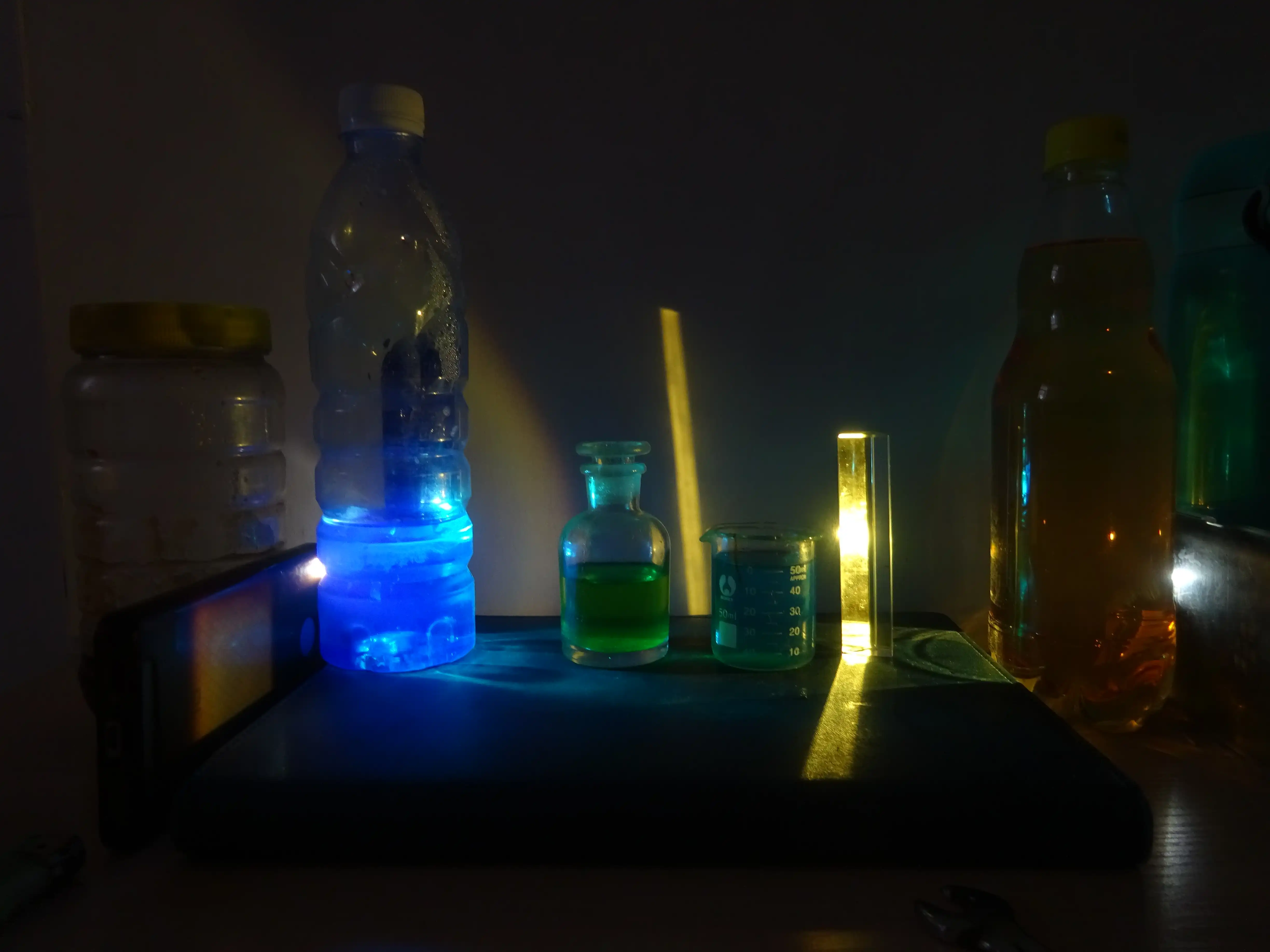 从左至右:硫酸铜(蓝色)、保护起来的二价铁(绿色)、氢氧化铜悬浊液(淡蓝)、菠萝味果啤(金黄色)